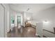 Bright hallway with hardwood floors leads to a sunroom with natural light at 2450 Norwood Park Xing, Atlanta, GA 30340