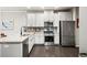 Well-lit kitchen featuring stainless steel appliances, white cabinets, and granite countertops at 2450 Norwood Park Xing, Atlanta, GA 30340