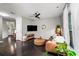Open living room with dark hardwood floors, a leather sofa, and a large window with sheer curtains at 2450 Norwood Park Xing, Atlanta, GA 30340