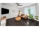 Cozy living room with dark hardwood floors, a leather sofa, and ample natural light at 2450 Norwood Park Xing, Atlanta, GA 30340