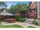 Serene backyard showcasing a stone patio with dining set, pergola, and stone steps, enhancing outdoor enjoyment at 26 Clarendon Ave, Avondale Estates, GA 30002