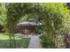 Backyard patio with a table and chairs, accessible through a stone walkway and an archway at 26 Clarendon Ave, Avondale Estates, GA 30002
