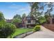 Picturesque backyard with stone patio, lush lawn, and mature trees creating a private outdoor space at 26 Clarendon Ave, Avondale Estates, GA 30002