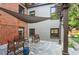 Relaxing backyard showcasing a stone patio with seating area and shade, blending brick and siding home features at 26 Clarendon Ave, Avondale Estates, GA 30002