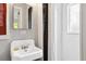 Bright bathroom with tiled shower, decorative mirror, and tiled walls at 26 Clarendon Ave, Avondale Estates, GA 30002