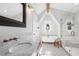 Bright bathroom featuring marble countertops, patterned floors, a glass shower, and a soaking tub at 26 Clarendon Ave, Avondale Estates, GA 30002