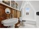 Cozy attic bathroom with rustic wood wall and black and white tile floor at 26 Clarendon Ave, Avondale Estates, GA 30002