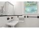 Classic bathroom featuring white subway tile, a pedestal sink, and a glass block window at 26 Clarendon Ave, Avondale Estates, GA 30002