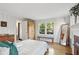 Sunlit bedroom with hardwood floors, large windows, and ample closet space at 26 Clarendon Ave, Avondale Estates, GA 30002