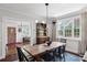 Classic dining room with a large window, hardwood floors, sideboard and stylish light fixture at 26 Clarendon Ave, Avondale Estates, GA 30002