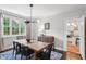 Elegant dining room with natural light, hardwood floors, stylish chandelier, and access to kitchen at 26 Clarendon Ave, Avondale Estates, GA 30002