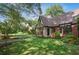 Charming brick home with Tudor-style accents, lush landscaping and covered porch at 26 Clarendon Ave, Avondale Estates, GA 30002