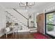 Inviting home foyer featuring staircase with built-ins, hardwood floors, and detailed wooden door at 26 Clarendon Ave, Avondale Estates, GA 30002