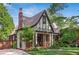 Charming Tudor-style home featuring a brick facade, pitched roof, and well-manicured front yard at 26 Clarendon Ave, Avondale Estates, GA 30002