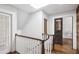 Bright upstairs hallway featuring hardwood floors, white trim, natural light, and wood accent wall at 26 Clarendon Ave, Avondale Estates, GA 30002