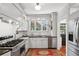 Bright kitchen featuring white cabinets, stainless steel appliances, and a window over the sink at 26 Clarendon Ave, Avondale Estates, GA 30002