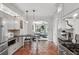 Open kitchen design with stainless steel appliances, hexagonal terra-cotta floors, and seating area at 26 Clarendon Ave, Avondale Estates, GA 30002