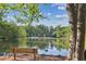 Beautiful lake view with a bench and a goose swimming in the tranquil water on a sunny day at 26 Clarendon Ave, Avondale Estates, GA 30002