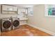 Laundry room includes washer, dryer, sink, and white cabinets at 26 Clarendon Ave, Avondale Estates, GA 30002