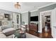 Comfortable living room with decorative walls, hardwood floors, and neutral sectional at 26 Clarendon Ave, Avondale Estates, GA 30002