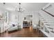 Open living room with hardwood floors, fireplace, staircase, and open floor plan at 26 Clarendon Ave, Avondale Estates, GA 30002