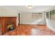 Living room with vintage fireplace and terracotta tile flooring and bay window at 26 Clarendon Ave, Avondale Estates, GA 30002