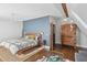 This main bedroom features hardwood floors, blue accent wall, comfortable seating, and a stylish armoire at 26 Clarendon Ave, Avondale Estates, GA 30002