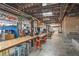 Spacious indoor market with high ceilings, exposed ductwork, vendor stalls, and communal tables for dining and socializing at 26 Clarendon Ave, Avondale Estates, GA 30002