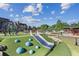 Modern community playground featuring a slide, climbing structure, and soft play elements for to enjoy outdoors at 26 Clarendon Ave, Avondale Estates, GA 30002