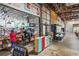 A bustling restaurant interior with colorful decor, open kitchen, and a mix of seating options, offering a vibrant dining experience at 26 Clarendon Ave, Avondale Estates, GA 30002