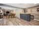 Finished basement bar with stone accents, modern lighting, and hardwood floors at 351 Old Orchard Ct, Marietta, GA 30068