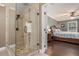 Modern bathroom with glass-enclosed shower, tiled walls, and neutral color palette, adjacent to bedroom at 351 Old Orchard Ct, Marietta, GA 30068