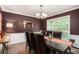 Formal dining room with wood floors, large windows, wainscoting, and a stylish chandelier at 351 Old Orchard Ct, Marietta, GA 30068