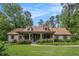 Charming home with stone accents, dormer windows, a lush lawn, and mature landscaping at 351 Old Orchard Ct, Marietta, GA 30068