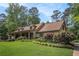 Inviting home exterior with a covered porch, stone accents, and beautiful landscaping at 351 Old Orchard Ct, Marietta, GA 30068