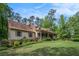 Inviting home exterior with a covered porch, stone accents, and beautiful landscaping at 351 Old Orchard Ct, Marietta, GA 30068