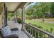 Cozy front porch with wicker furniture and a view of the landscaped front yard at 351 Old Orchard Ct, Marietta, GA 30068