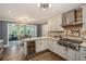 Well-designed kitchen featuring granite counters, stainless appliances, tile backsplash, and wine storage at 351 Old Orchard Ct, Marietta, GA 30068