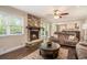Cozy living room with stone fireplace, hardwood floors, and natural light from large windows at 351 Old Orchard Ct, Marietta, GA 30068