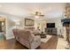 Comfortable living room with a stone fireplace, ceiling fan, and hardwood floors at 351 Old Orchard Ct, Marietta, GA 30068