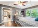 Comfortable bedroom featuring a large window and TV over dresser leading to bathroom at 351 Old Orchard Ct, Marietta, GA 30068