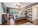 Well-lit bedroom with a decorative wall, a queen-sized bed, and hardwood floors at 351 Old Orchard Ct, Marietta, GA 30068