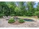 Aerial view of a backyard pool area featuring a stone-lined pool, hot tub, and lush greenery at 351 Old Orchard Ct, Marietta, GA 30068