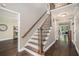 Traditional staircase with wood railing, iron spindles, and hardwood floors in a home's entry at 351 Old Orchard Ct, Marietta, GA 30068