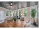 Bright sunroom with hardwood ceiling, many windows, comfortable seating, and a decorative tree at 351 Old Orchard Ct, Marietta, GA 30068