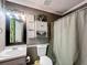 This bathroom features a shower with a decorative curtain and a complimentary wall hanging set at 505 Blake Dr, Douglasville, GA 30134