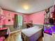Cozy bedroom featuring a light colored wood floor, neutral lower wall and soft pink upper wall at 505 Blake Dr, Douglasville, GA 30134