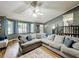 Bright living room with a large sectional, hardwood floors, and multiple windows providing lots of natural light at 505 Blake Dr, Douglasville, GA 30134