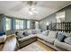 Spacious living room boasting a large sectional sofa, hardwood floors, and ample natural light from large windows at 505 Blake Dr, Douglasville, GA 30134