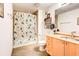 Bathroom features neutral tones, patterned shower curtain, and updated vanity at 170 Boulevard # H201, Atlanta, GA 30312